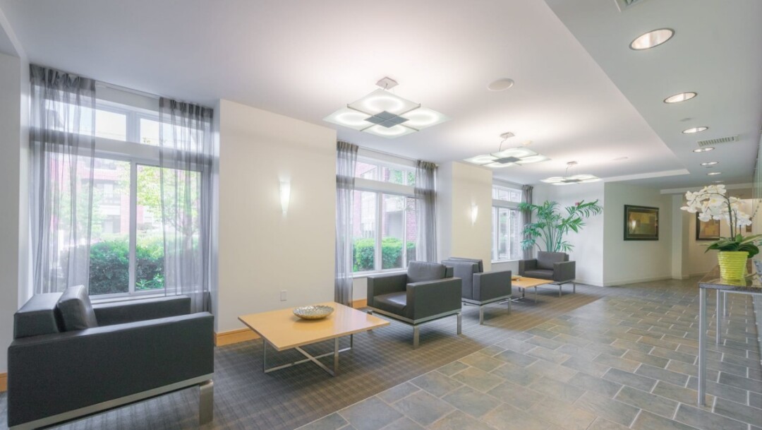 Bright resident lobby with chairs and tables and large windows