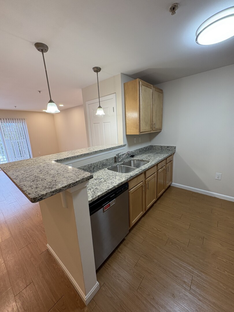 updated kitchen with oak cabinets and wood floors