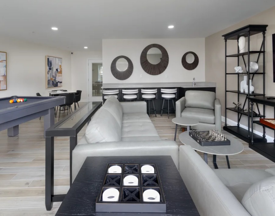 Resident lounge with billiards table, lounge seating, and games